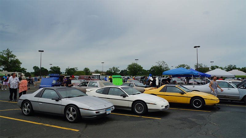 Multiple cars lined up in a parking lot.