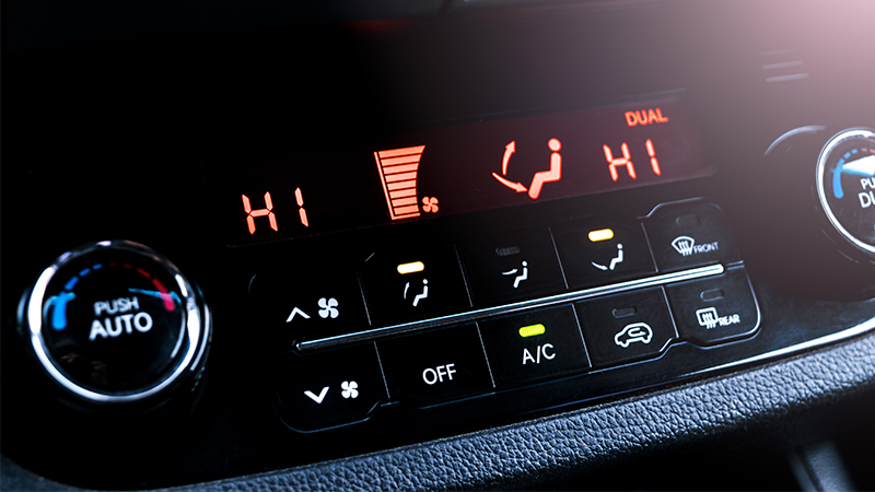 A closeup view of a vehicle's A/C controls set to high