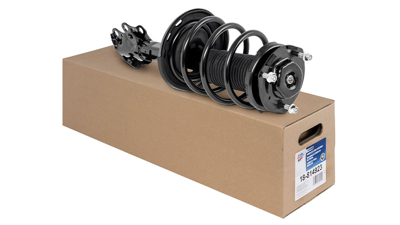 Carquest strut assembly on top of cardboard packaging