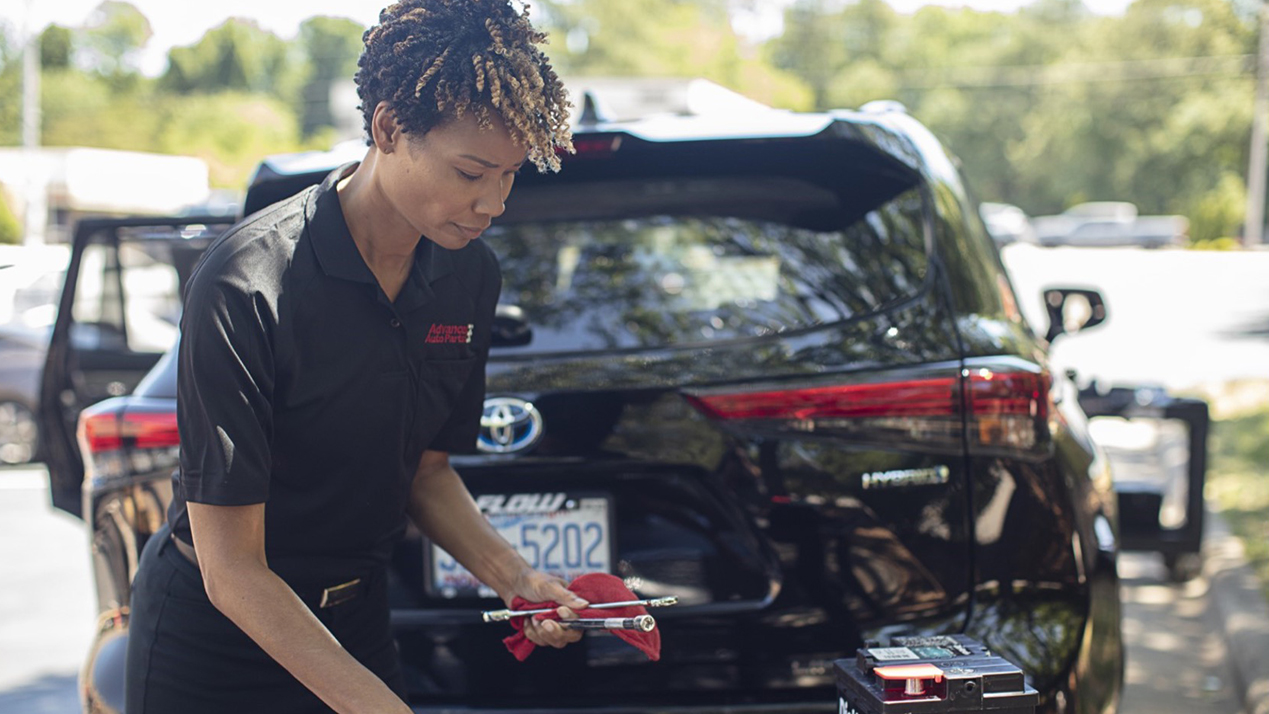 Employee using tools to change battery