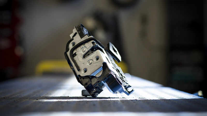 a Dorman door lock actuator on a table