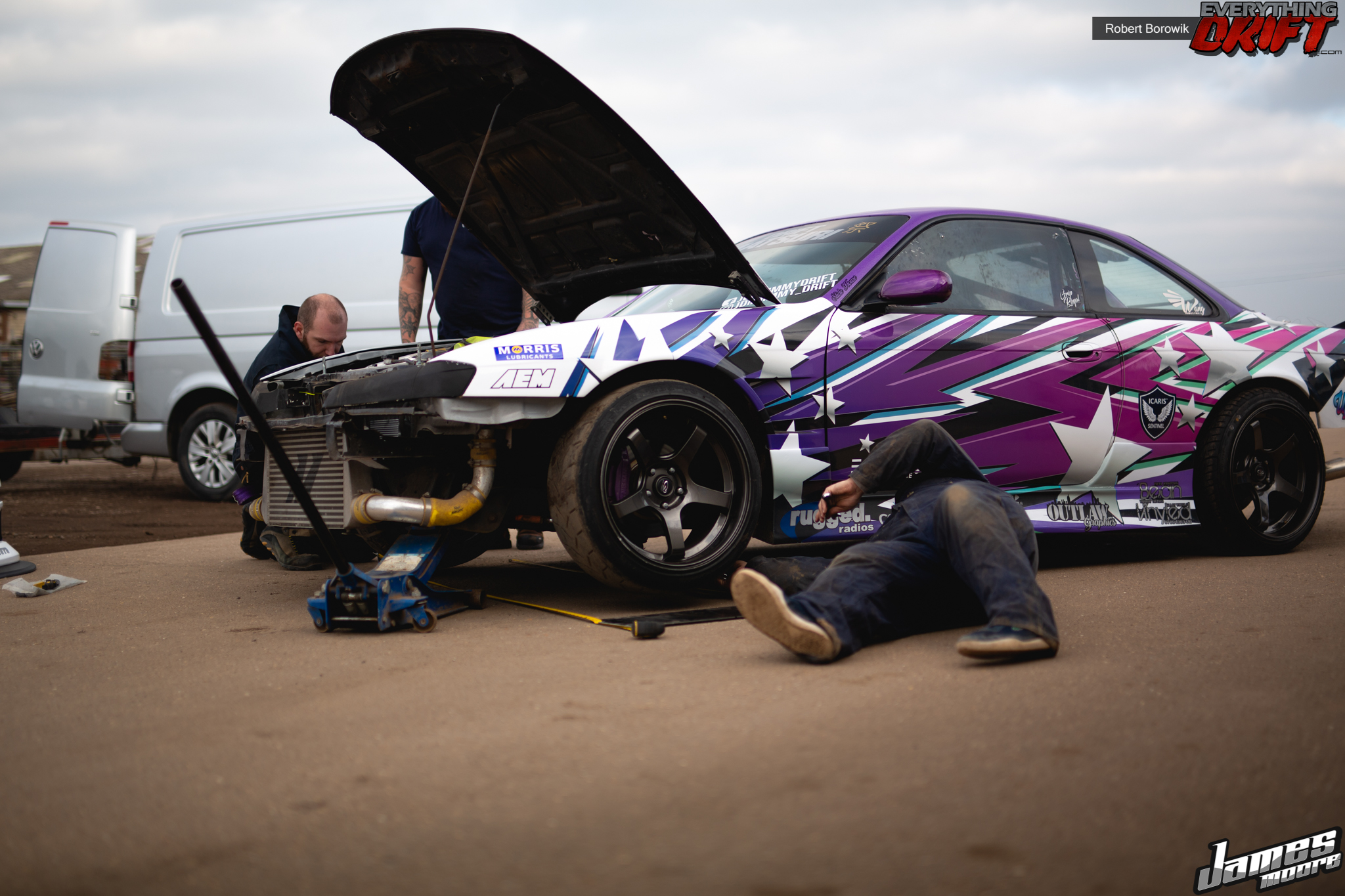 Working on a drift car with the hood raised