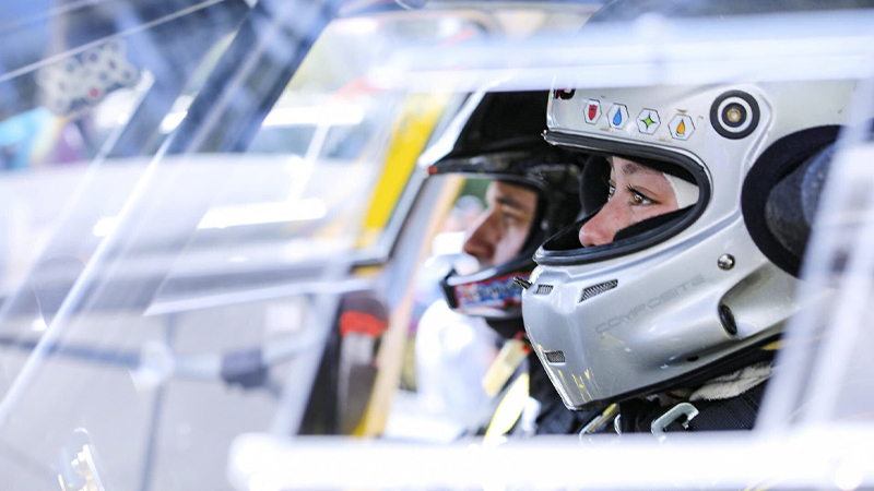 side view of Keanna Erickson-Chang and her co-drover with helmets on