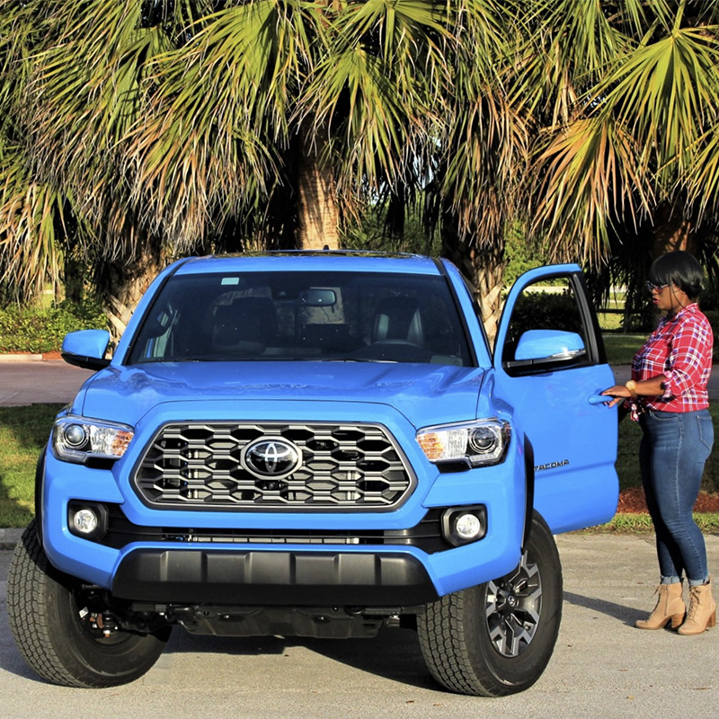 Woman getting into a Toyota Tacoma