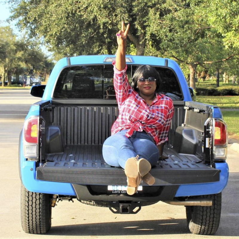 Stylish woman in the bed of a truck