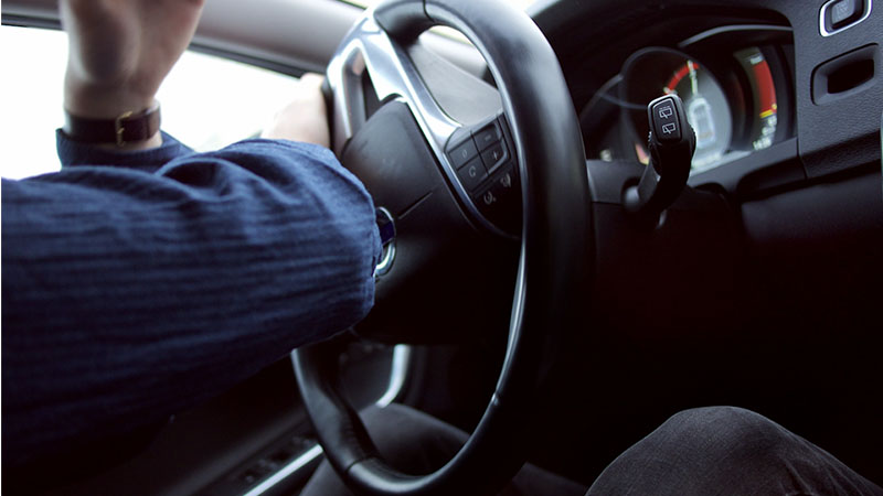 driver sharply turning a steering wheel