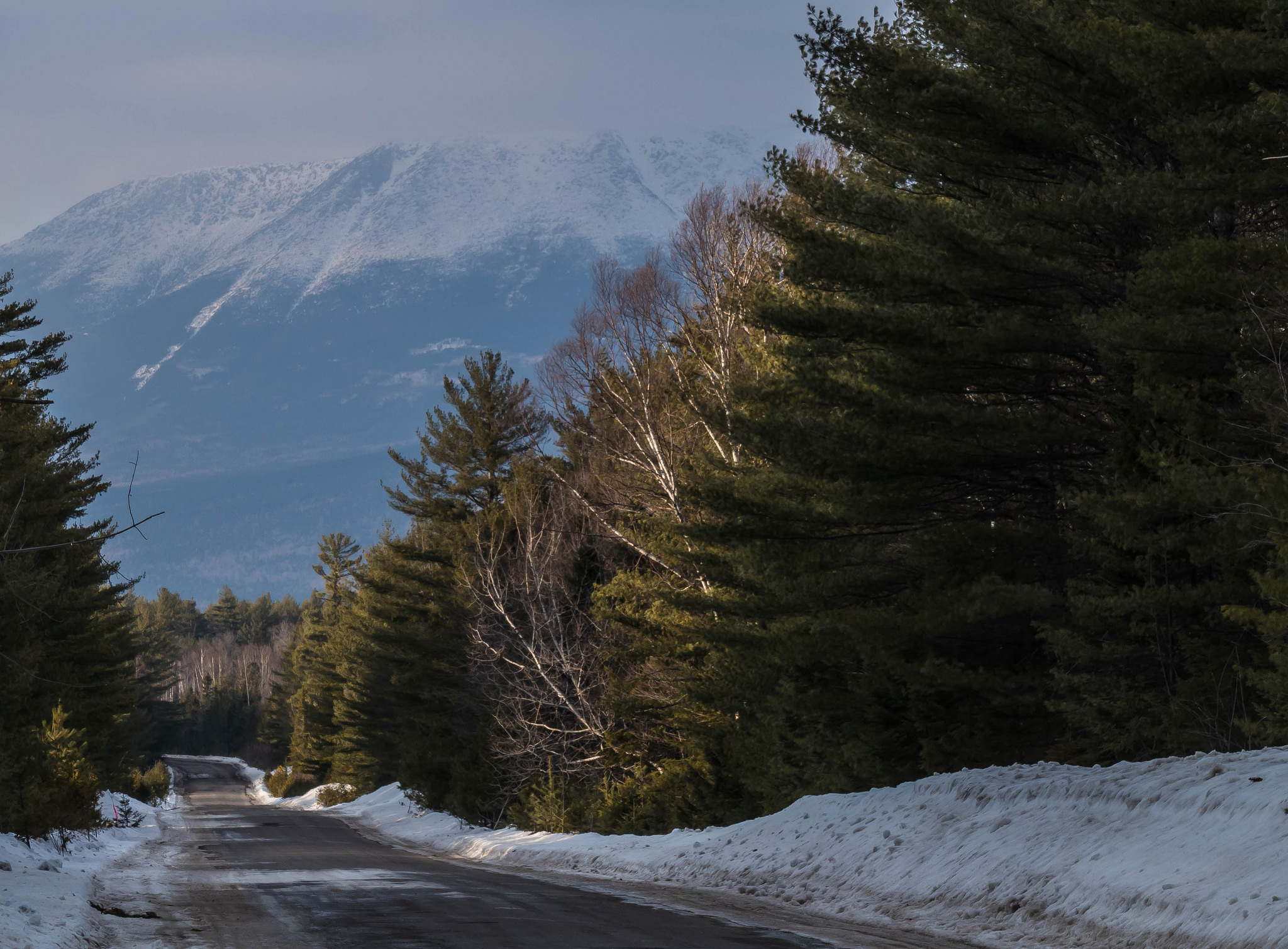 snowy road at the foot of a mountain
