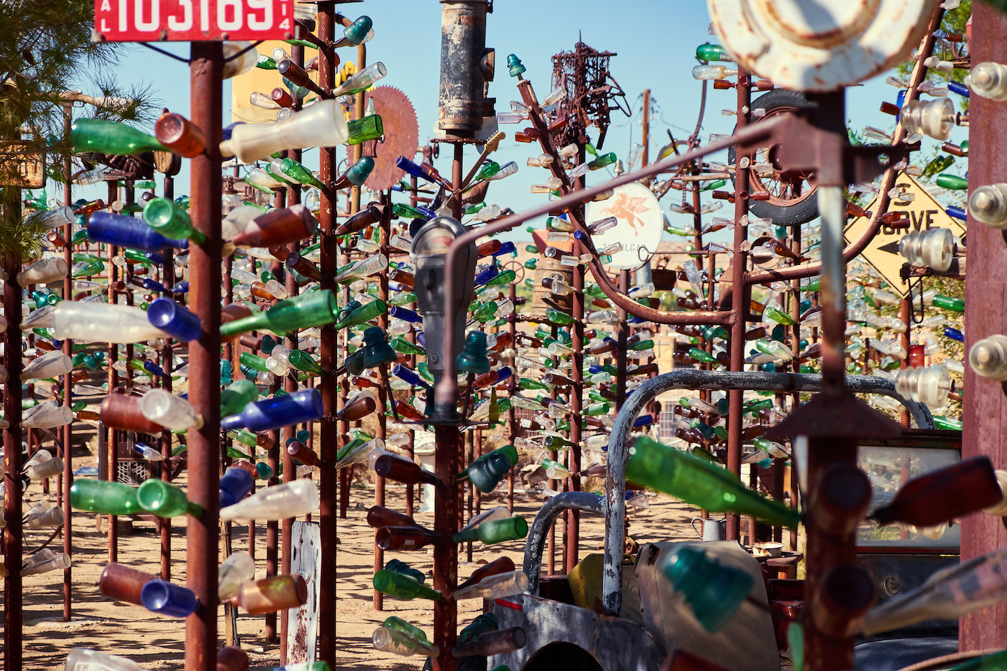 Metal sculptures with glass bottles connected to them