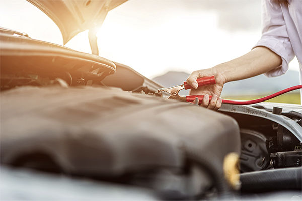 woman outside jumping a battery