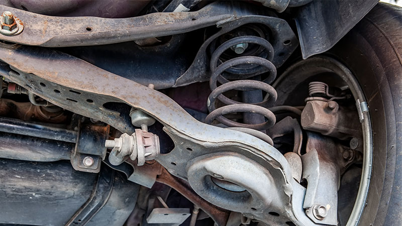 a coil spring mounted between upper and lower control arms