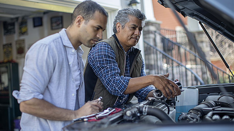 father and son working under the hood
