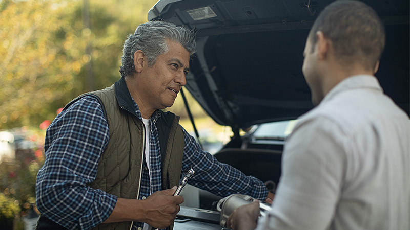 father and son working under the hood