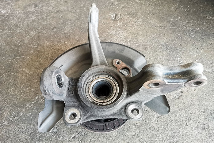 a hub assembly removed from the vehicle showing the wheel bearings pressed into the center