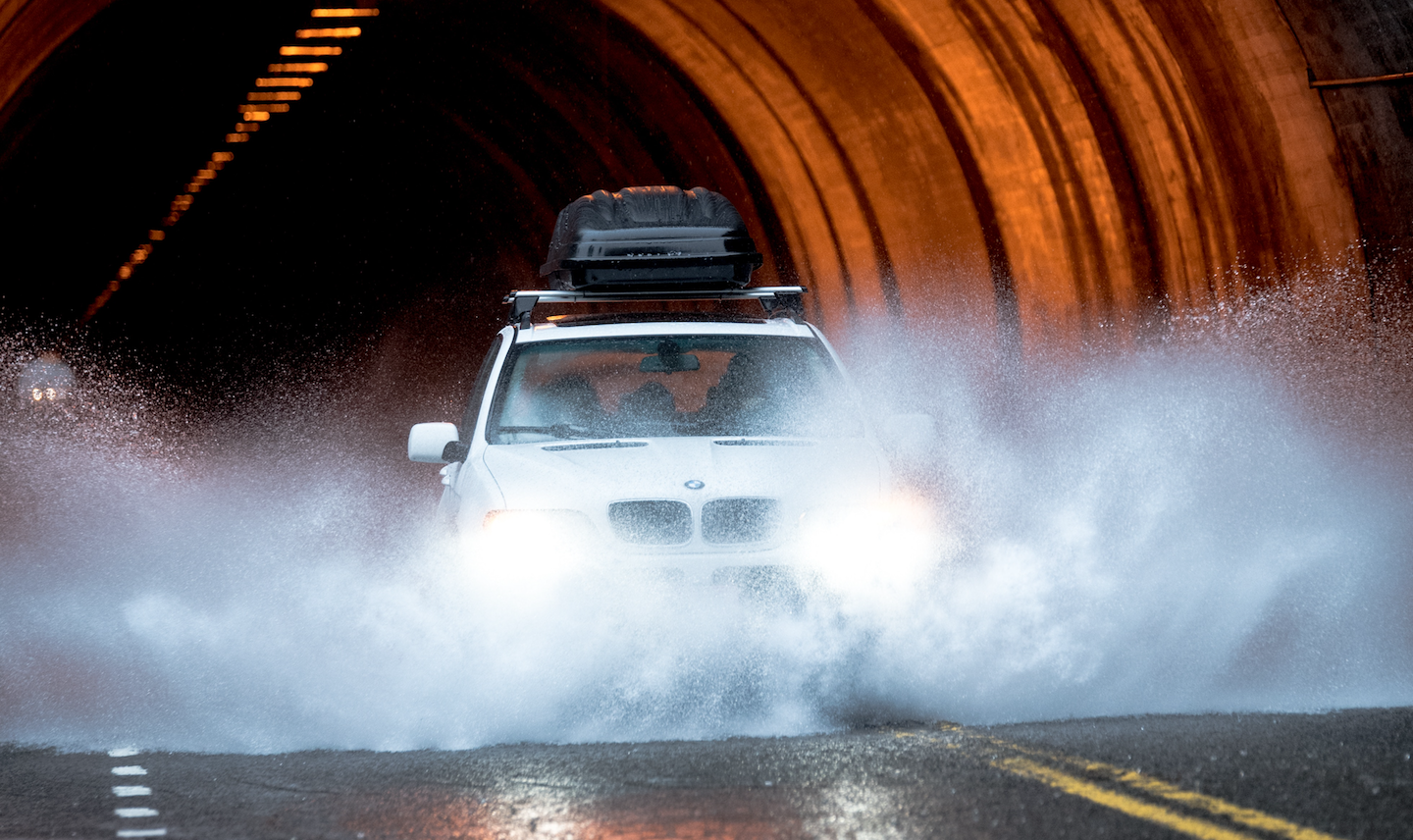 Image of car driving through flooding