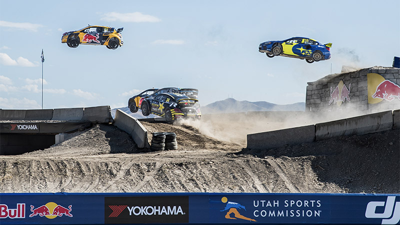 three rally cars are airborne on a Nitro Rallycross course