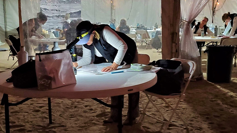 women navigating in a tent