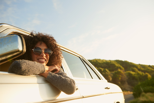 woman leaning out of car window