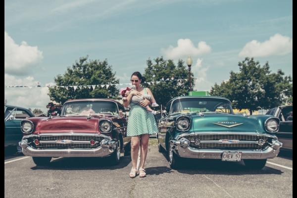 woman and child in used car sales lot