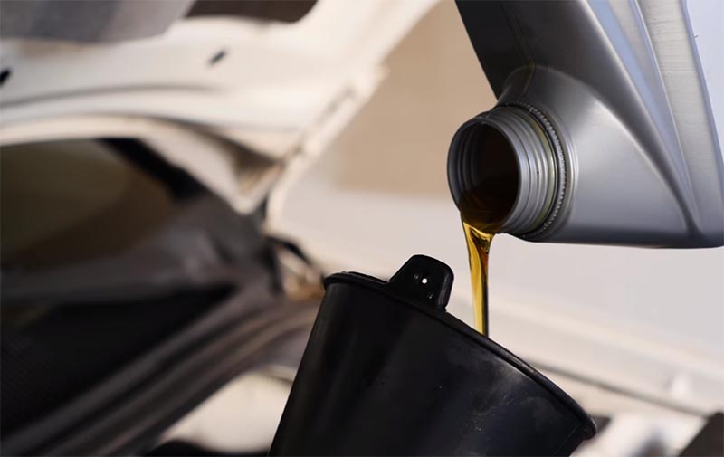 pouring engine oil