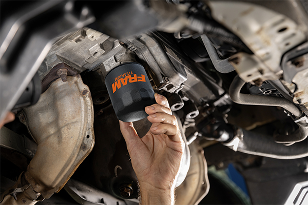 FRAM Titanium™ oil filter being installed