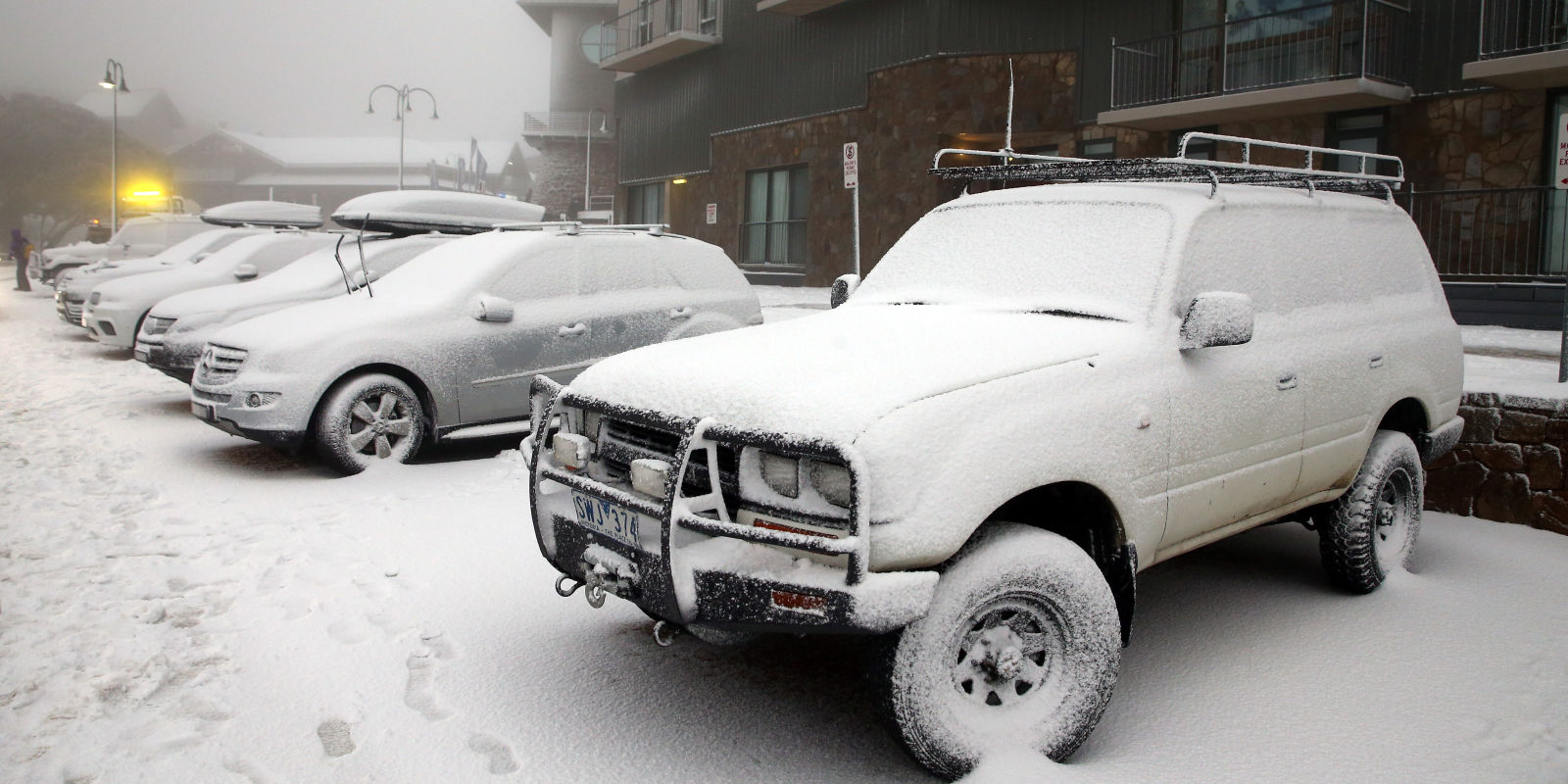 Cars covered in snow