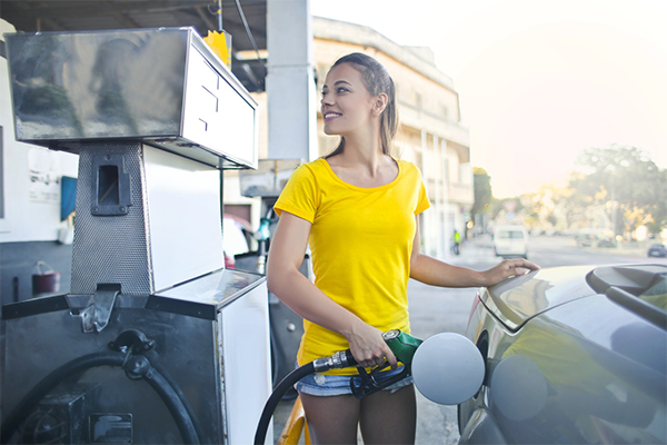 woman getting gas 