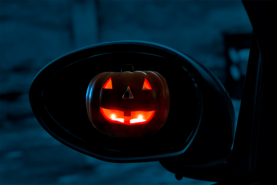 jack-o-lantern reflection in side mirror