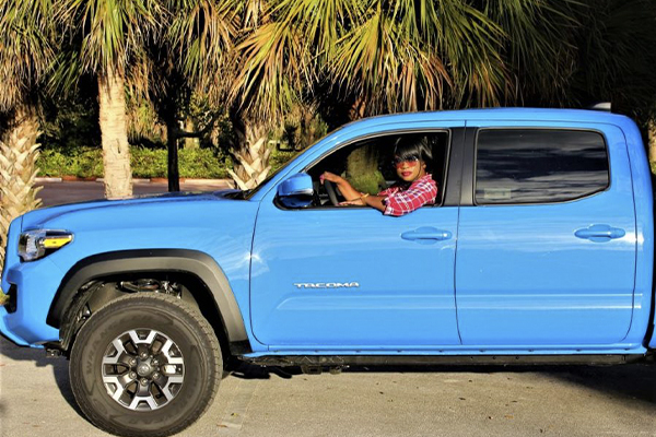 Dawn in a blue Toyota Tacoma