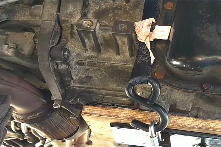 tie-down strap secured around the transmission