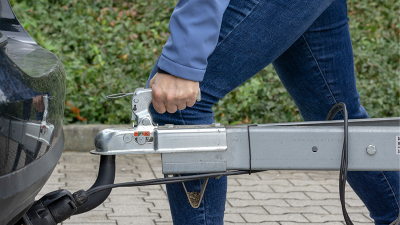 woman setting a tow hitch