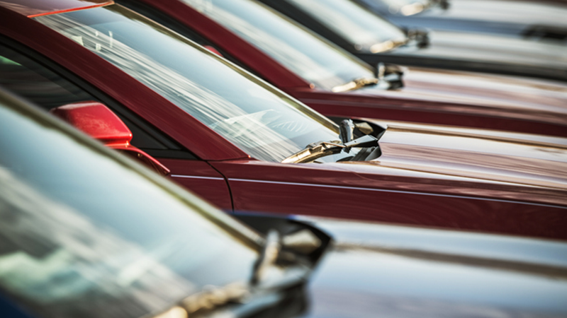Cars lined up in a sale lot.