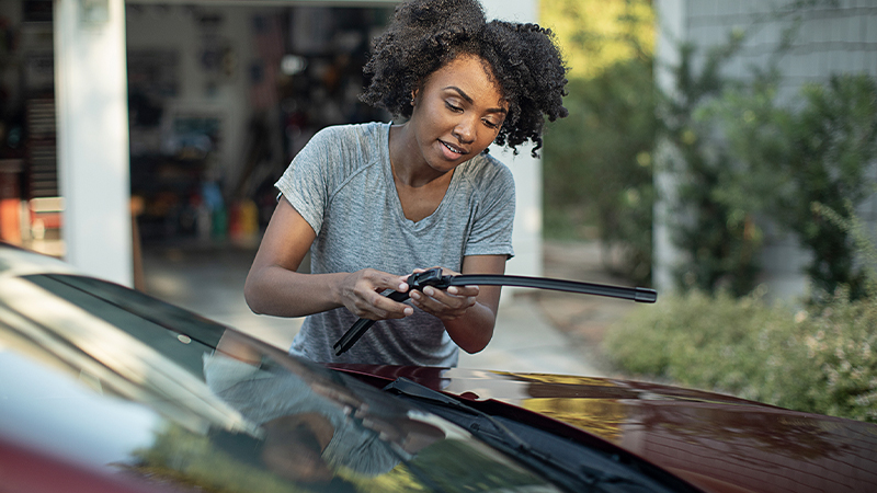 a woman replacing wiper blades