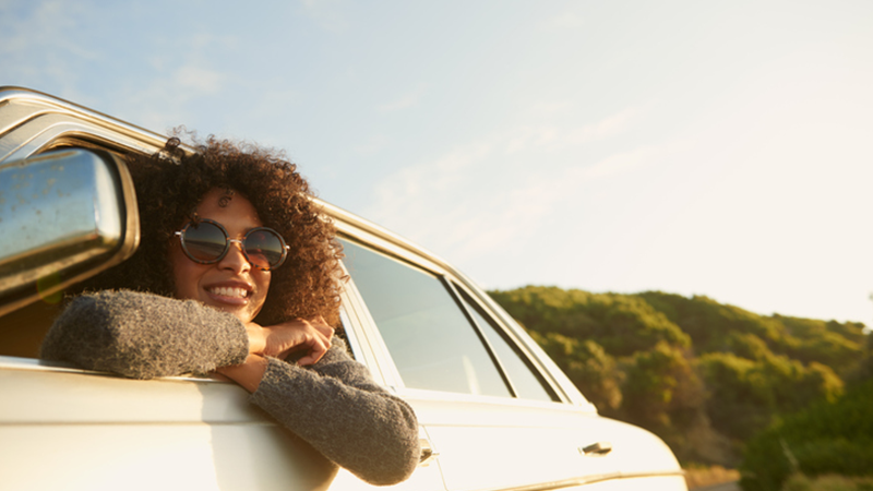 woman leaning out of car window